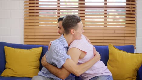 happy couple hugging on couch