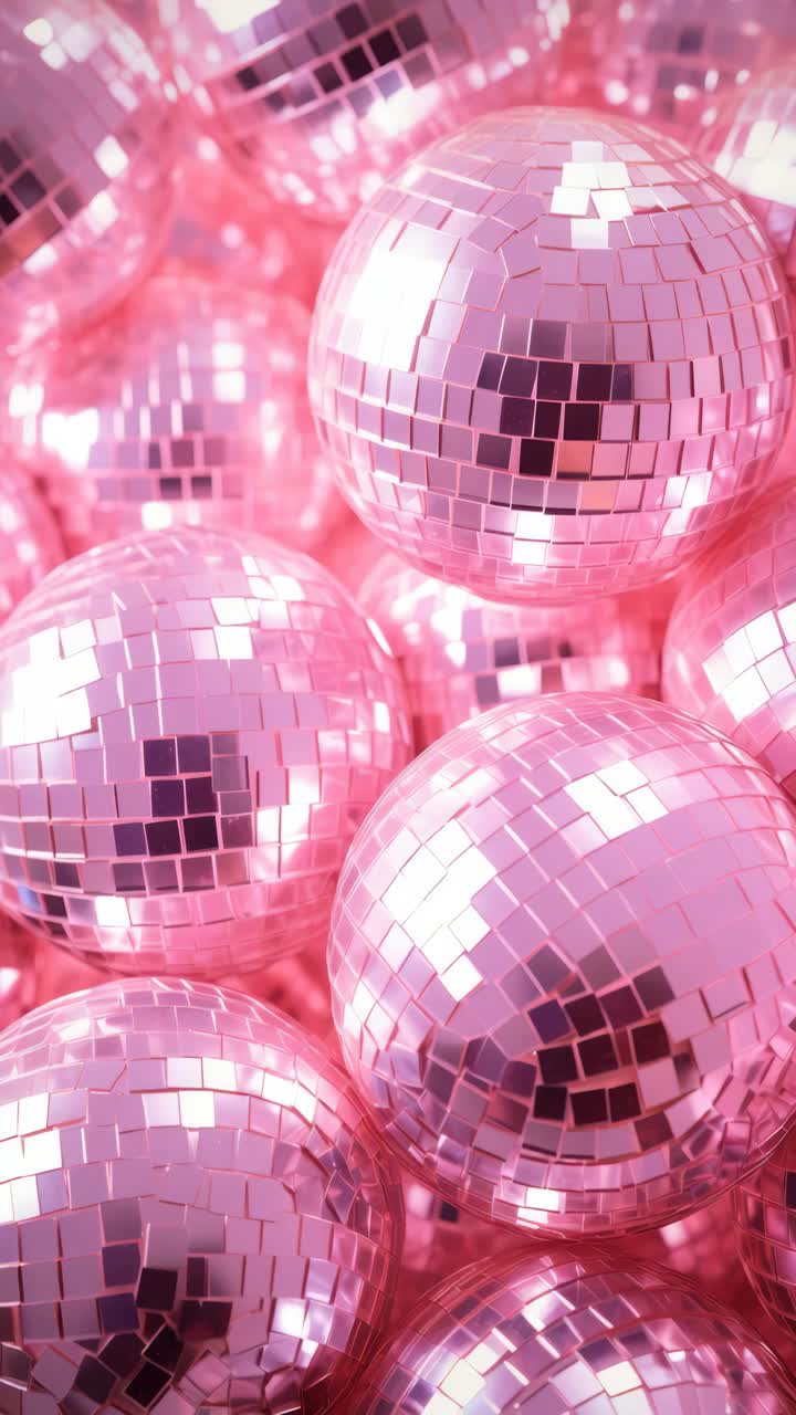 A vibrant, close-up shot of pink disco balls, capturing a retro, glamorous vibe
