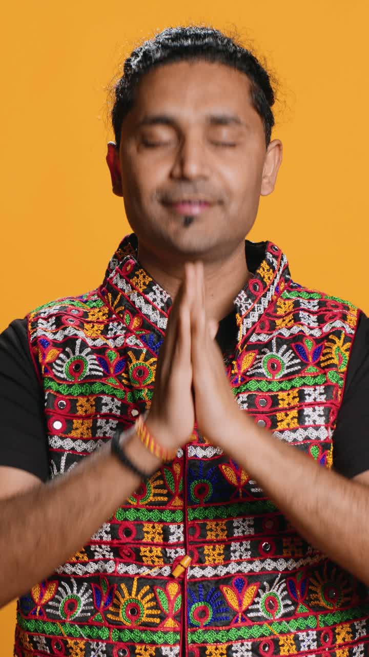 Indian Man Praying with Hands Clasped in Traditional Attire