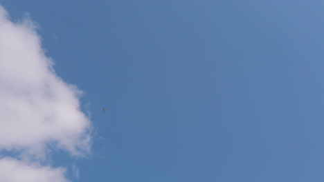 Light-aircraft-flying-over-the-clear-blue-skies-of-the-English-countryside