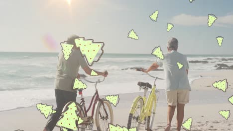 Animation-of-tree-cookies-over-senior-biracial-couple-at-beach