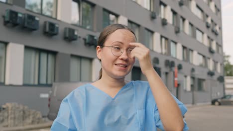 woman displaying mixed body language of being uneasy, nervous, or uncomfortable while wearing blue coat