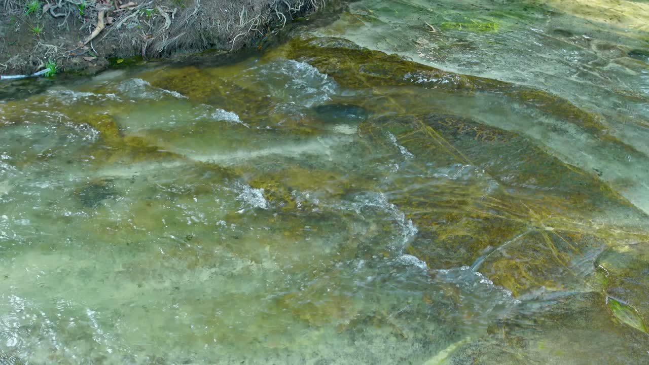 Serene stream over rocks, Kbal Chay waterfall in Sihanoukville, calm nature scene