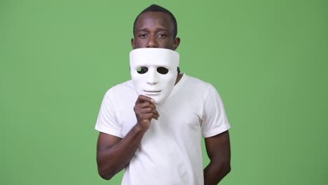 young african man with white mask