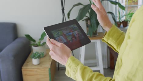 Caucasian-woman-wearing-yellow-shirt-and-using-tablet