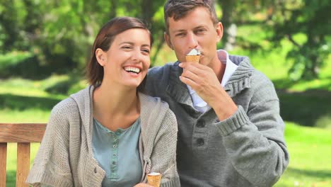 young couple eating icecream outdoors