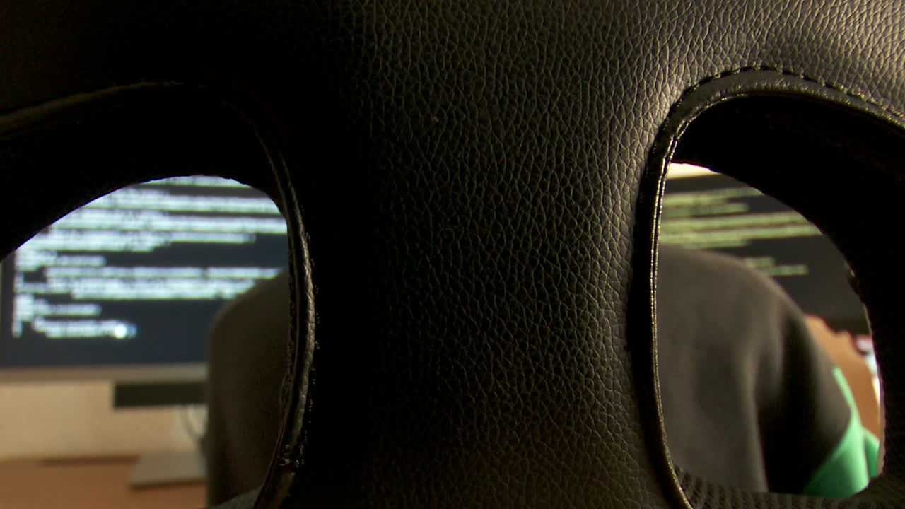 Person coding in front of a computer