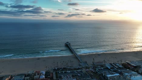 sunset scenery at manhattan beach pier in california - aerial drone shot