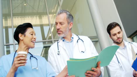 three doctors discussing while walking