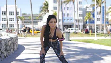 Pretty-happy-sportswoman-training-in-park