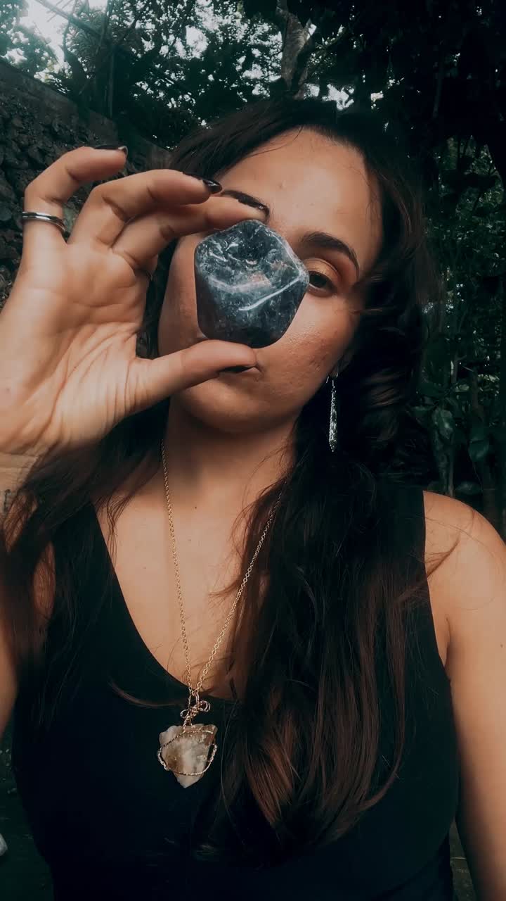 Woman holding a crystal outdoors