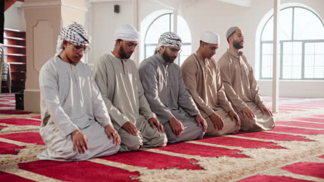 muslim men praying in a mosque