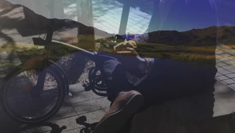 sitting on bicycle, person with scenic mountain overlay in animation style