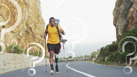 Animation-of-question-marks-moving-over-african-american-hiker-with-prosthetic-leg-walking-on-road