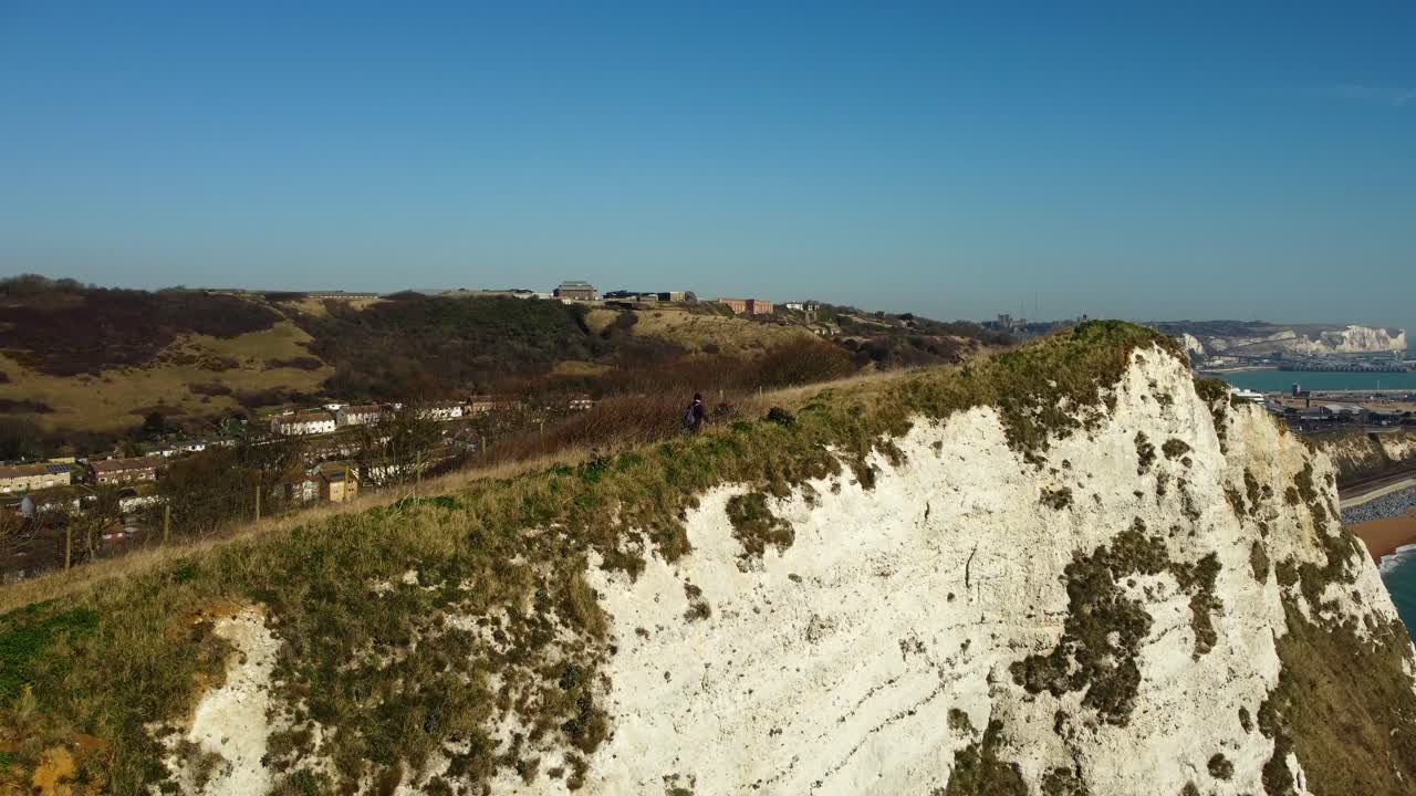 Scenic view of white cliffs with a person walking on top