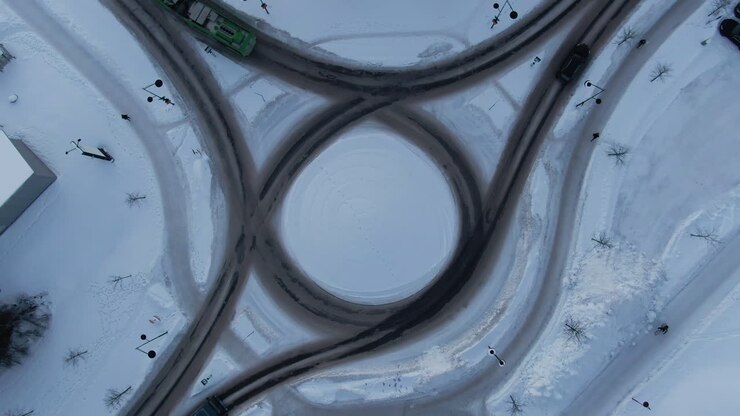 Birds Eye View Over Roundabout In Snow With Vehicles, Umea Sweden
