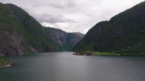 Aerial dolly over stunning large fjord under cloudy sky on Norway&#039;s west coast
