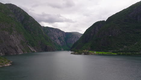 aerial dolly over stunning large fjord under cloudy sky on norway's west coast