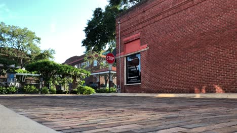 ground level view of a cobble stone street looking towards a brick building in a historic town