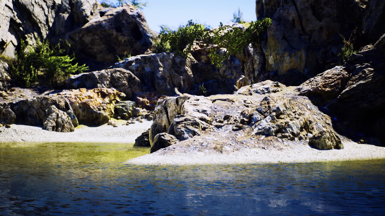 Scenic rocky shoreline with clear water and lush vegetation during daytime