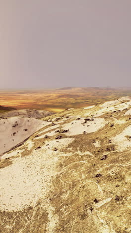 vast desert landscape showcasing rolling dunes and colorful terrain at dusk