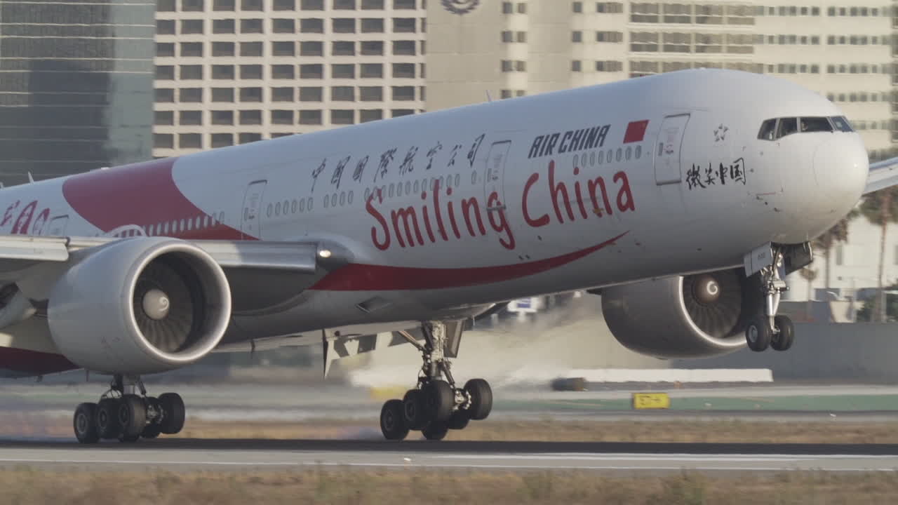 An Air China Boeing B777 touches down at Los Angeles International Airport in slow motion.