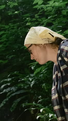 woman observing a stream in a forest