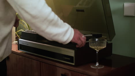 man putting a vinyl disc on