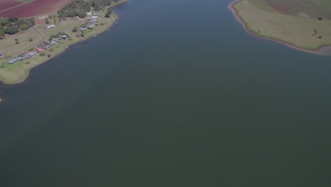 lake tinaroo reservoir surrounded by lush green fields in atherton tablelands, qld, australia