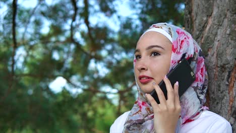 woman talking on phone in a park