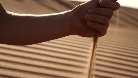 hand in desert sand