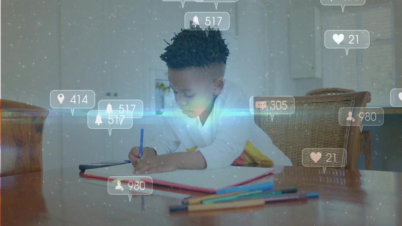 Student boy studying at table writing homework, social icons appearing with blue flare over chest