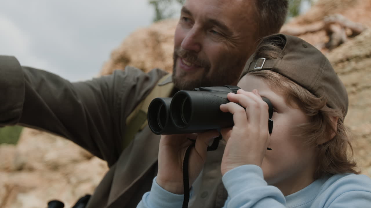 Father and Son Exploring Nature with Binoculars