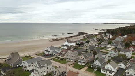 a serene overhead look of the residential homes bordering a beach in maine