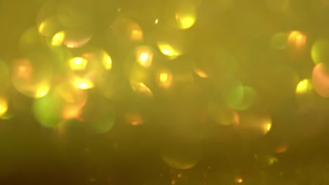 enfocando el fondo parpadeante. textura borrosa de resplandor dorado. textura sin costuras con pañuelos de oro amarillo