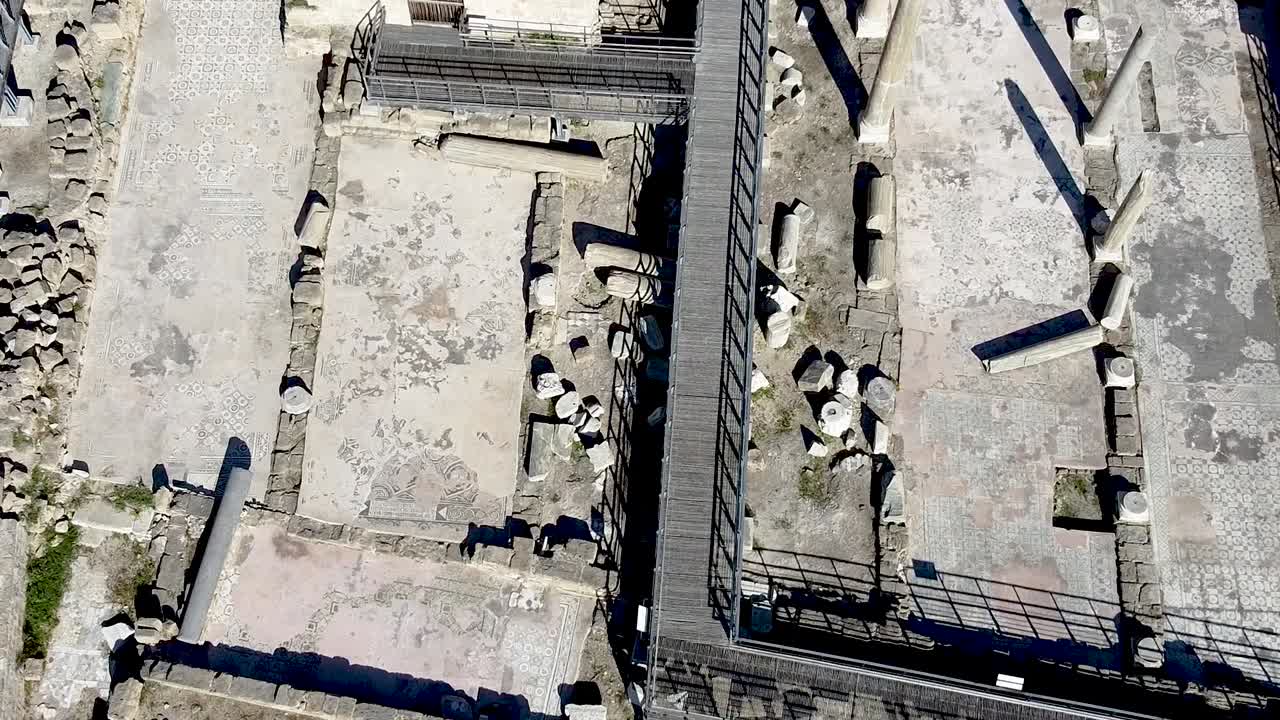 Discover the breathtaking landscape of ancient ruins under bright sunshine. Explore the intriguing history of this archaeological site with scattered pillars and stone remains