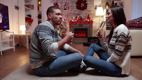 Zoom-in-shot-of-young-couple-drinking-champagne