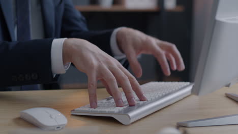 businessman typing on a computer