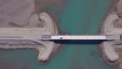 car driving over bridge in east iceland at breiðdalsvík fjord, top down