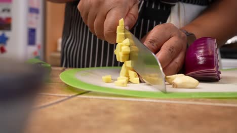 chopping ginger root and garlic cloves - chana masala series