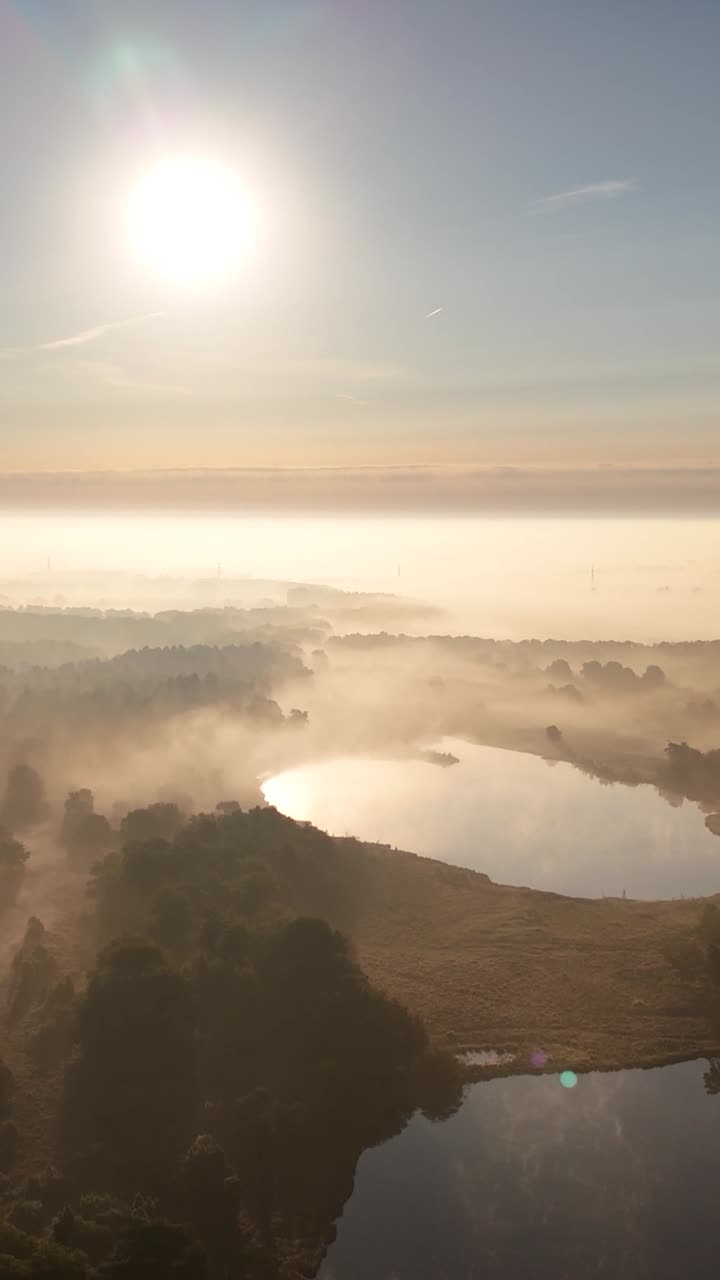 Aerial View of Misty Lake Landscape at Sunrise