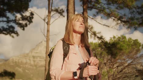 active senior woman hiking in forest