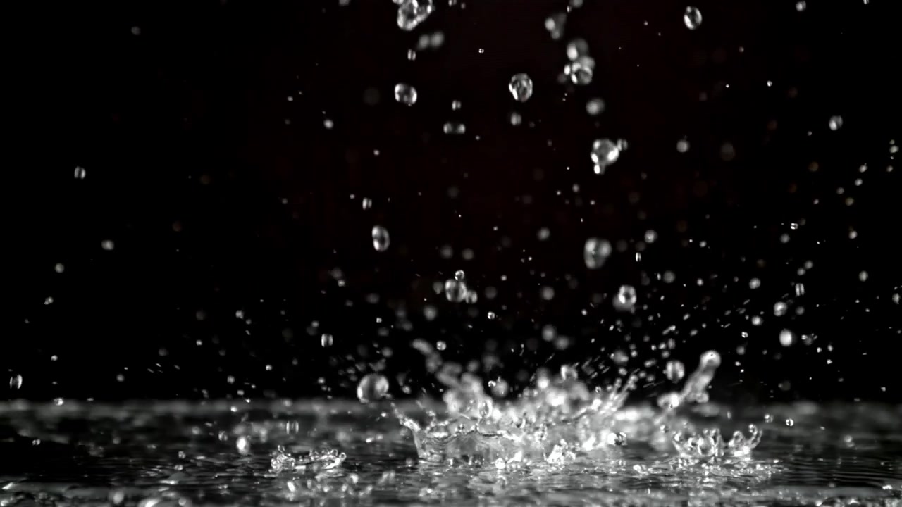 Slow Motion Water Droplets Splashing Against a Black Background