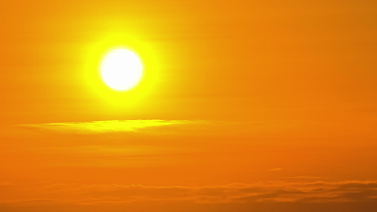 Time lapse shot of orange sunset at sky during foggy day in nature