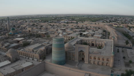 Aerial-drone-point-of-the-Itchan-Kala-and-Alla-Kouli-Khan-Madrasa-at-the-old-walled-city-of-Khiva-in-Uzbekistan