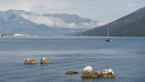 Sailing-boat,-calm-sea-and-mountains,-Adriatic-sea,-Montenegro