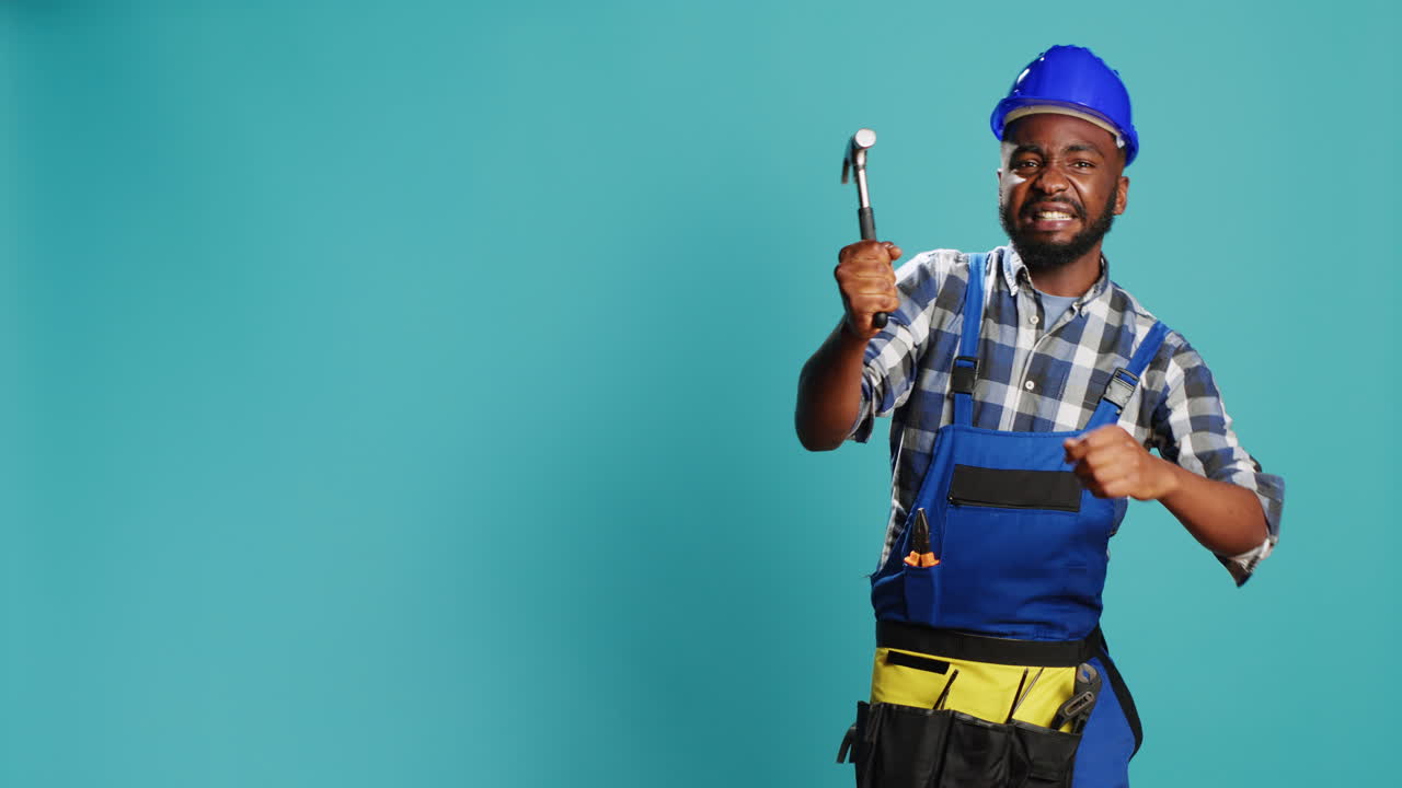 Construction worker hitting something with hammer