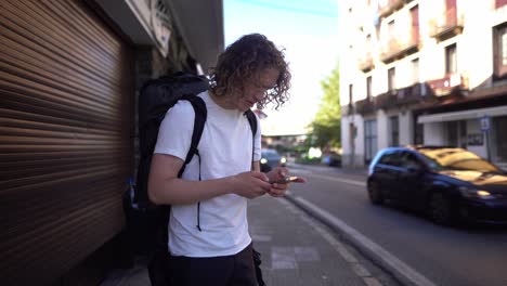 Young-backpacking-hiker-man-is-lost-trying-to-find-direction-on-phone