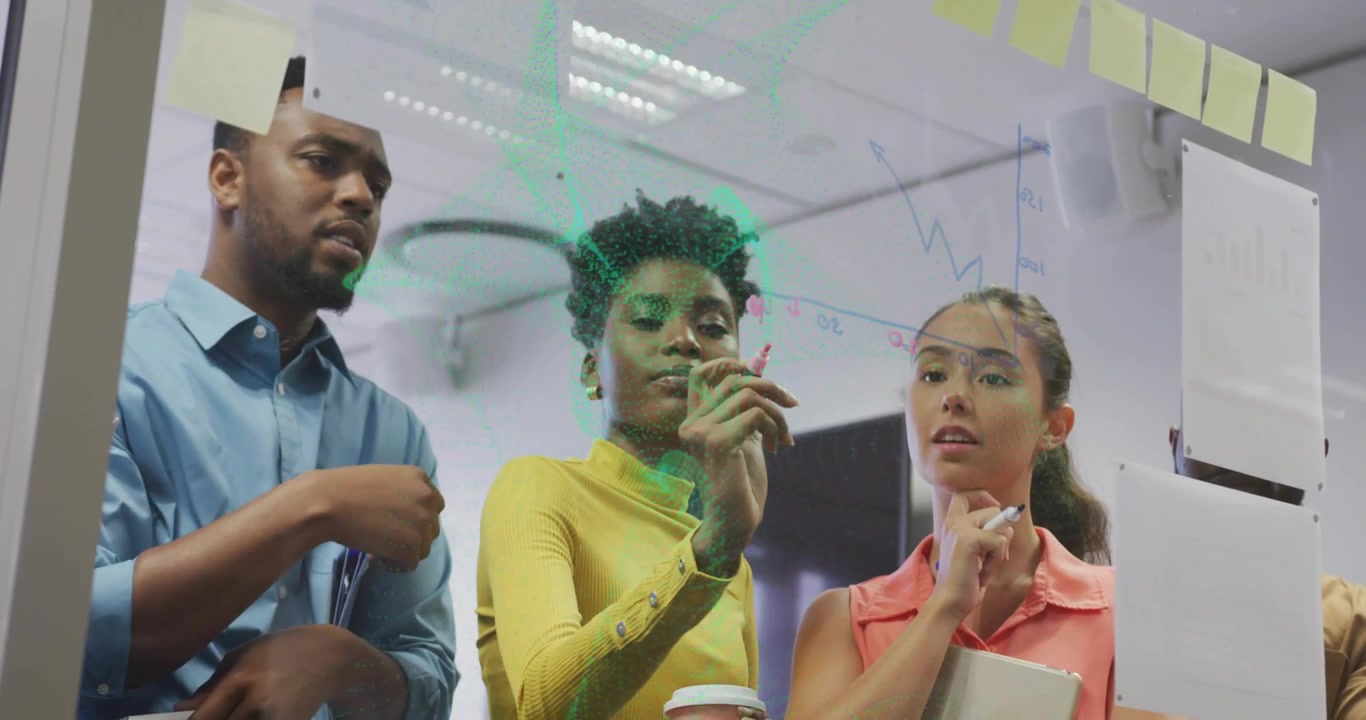 Business team studying data on glass board woman lifting pink marker animating graphs for insight