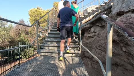 walking up the stairs of acropolis in athens, greece.